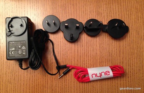 The worldwide power adapters and 3.5mm aux cable included with the Nyne Bass.