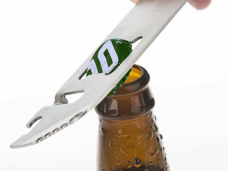 Barbarian Bar Tools' Simple Tool opening the crown top on a bottle.