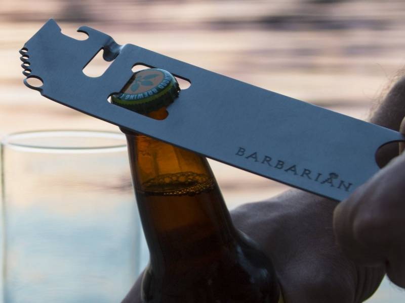 Barbarian Bar Tools' Simple Tool opening the crown top on a bottle.