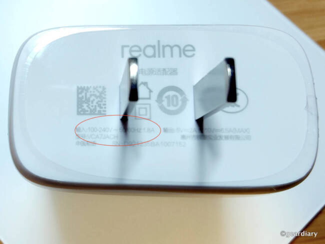 Realme 65W SuperDart Charger showing that it works with 100-240V electrical outlets