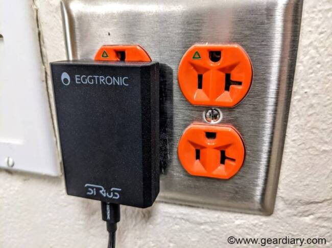 Eggtronic Sirius 65W Universal Charger plugged into wall outlet