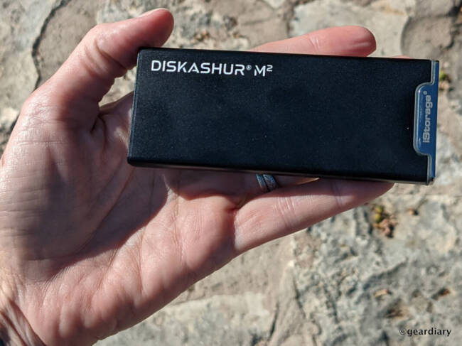 iStorage diskAshur M2 in protective sleeve held in the author's hand.