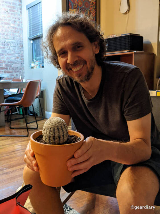 A man happy to have his new potted cactus.