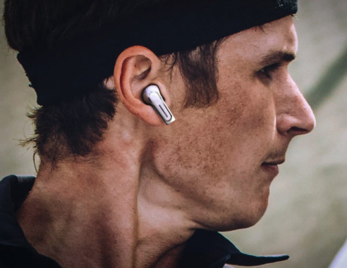 Man wearing the Olive Pro Audio Enhancing Earbuds.