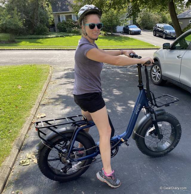 A woman sits on the Espin Nesta electric bicycle.