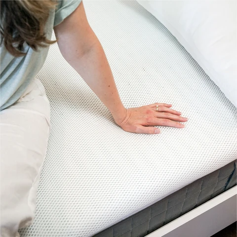 Perfectly Snug Smart Topper on a bed