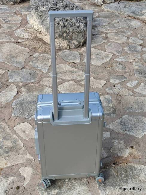 The telescoping handle extended on the 20" LEVEL8 Gibraltar Full Aluminum Carry-On; seen from the backside of the suitcase.
