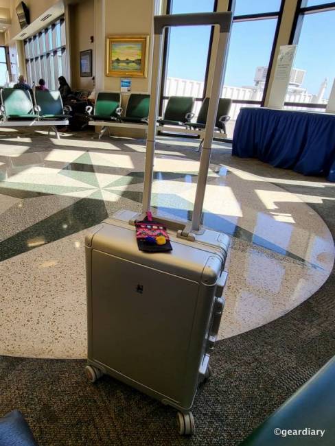 20" LEVEL8 Gibraltar full aluminum carry-on with handle extended in the gate lobby of a local airport.
