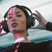 Woman wearing the Master & Dynamic MG20 Wireless Gaming Headphones in black
