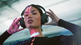 Woman wearing the Master & Dynamic MG20 Wireless Gaming Headphones in black