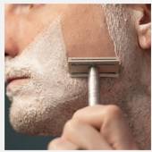 Henson AL13 Razor being use on a man's face