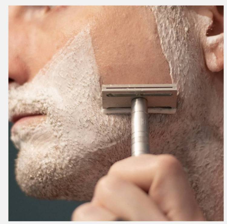 Henson AL13 Razor being use on a man's face