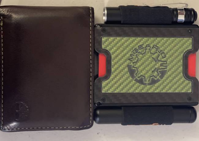 a regular wallet next to the MGear Gadget Wallet 3.0 
