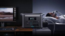 Man sleeps wearing a CPAP mask on his face; his CPAP is powered by the Anker 757 Portable Power Station