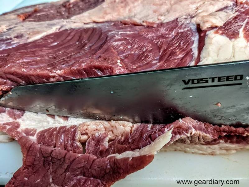 raw meat slicked with the Vosteed Morgan Chef's Knife