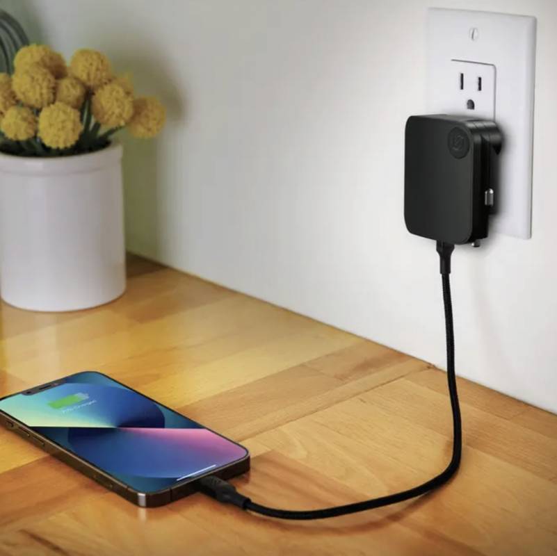Scosche PowerVolt Traveler30 plugged into a wall and charging a phone