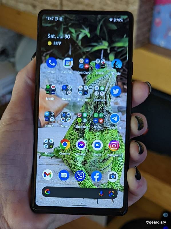 Google Pixel 6a in the author's hand with the home screen showing