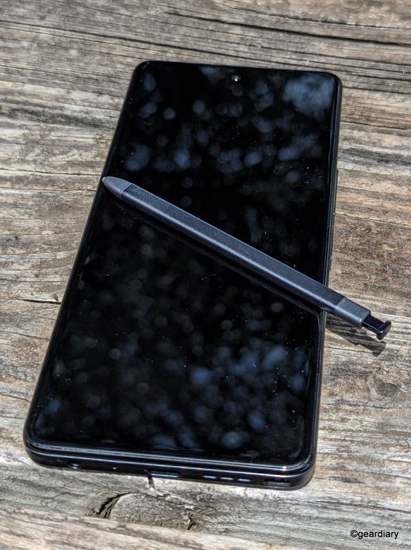 The TCL Stylus 5G with its stylus lying on the display