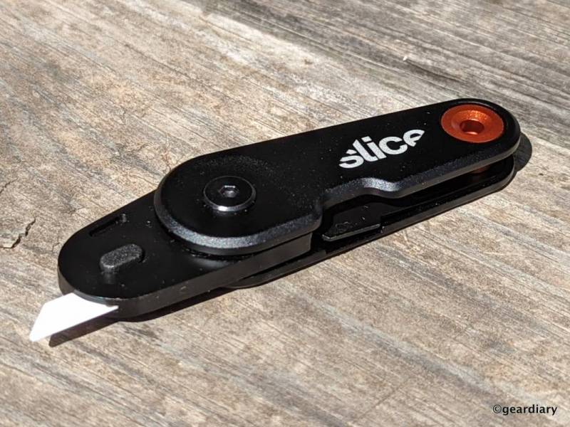 Slice EDC Folding Knife open on a wood table. 