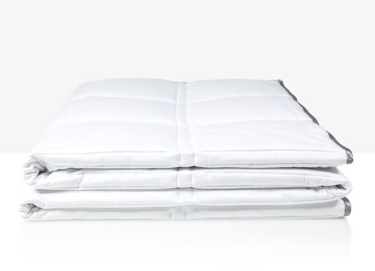A white, folded Eli & Elm Weighted Comforter