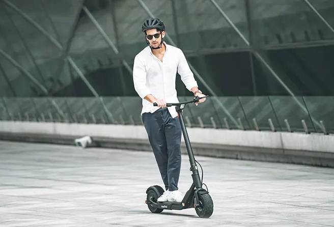 A man riding a MaxFind G5 Pro electric scooter
