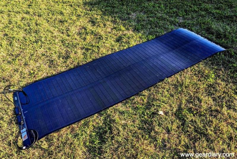 The unrolled Yuma 200W CIGS Flexible Solar Panel lying on grass.