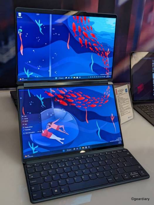The Lenovo Yoga Book 9i shown in dual-screen vertical mode with a physical keyboard at its base. 