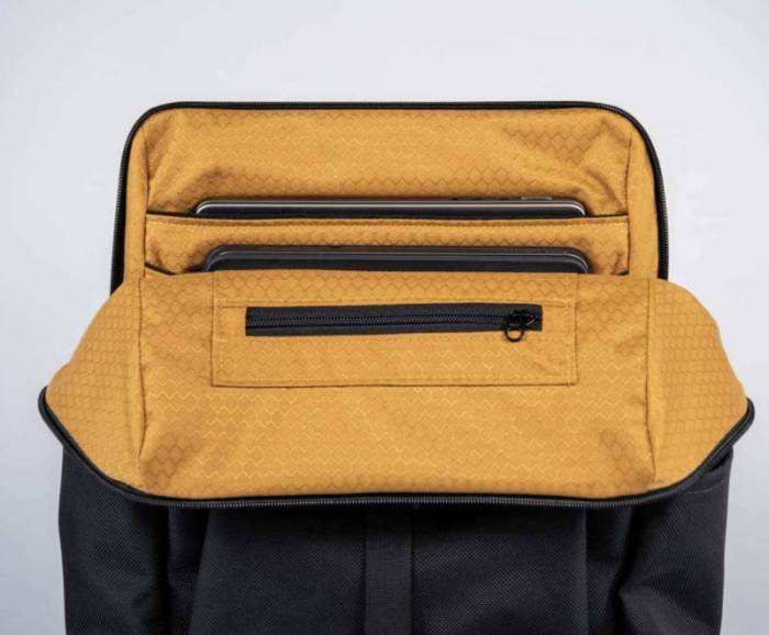 The zipper on the WaterField Miles Laptop Backpack opened showing the two laptop storage compartments.