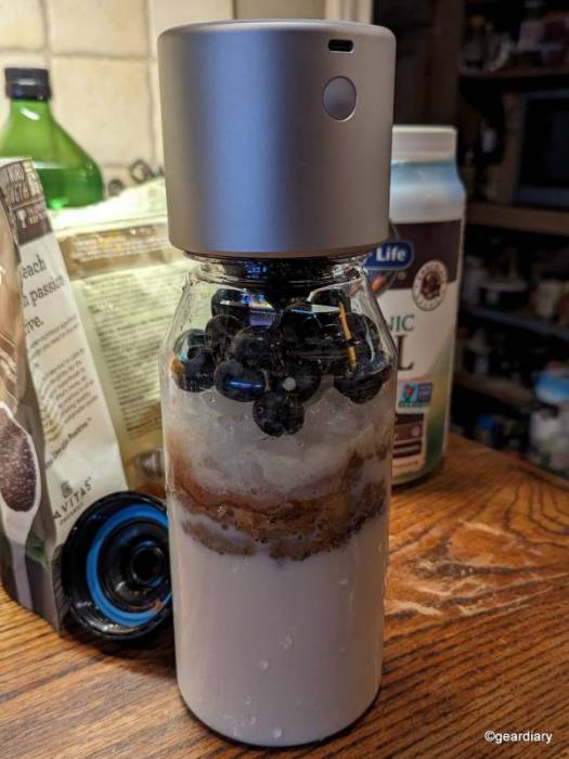 Placing the BlenderCap by Cruz on top of the bottle of raw ingredients before making a smoothie