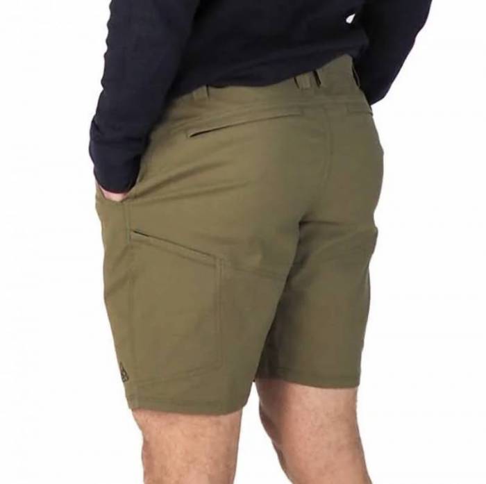 Rear view of a man wearing an army green pair of LIVSN Ecotrek Trail Shorts; you can see the left zippered hip pocket and a zippered pocket on the rear left leg. 