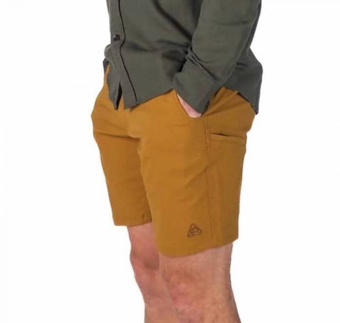 Man wearing a pair of yellowish LIVSN Ecotrek Trail Shorts