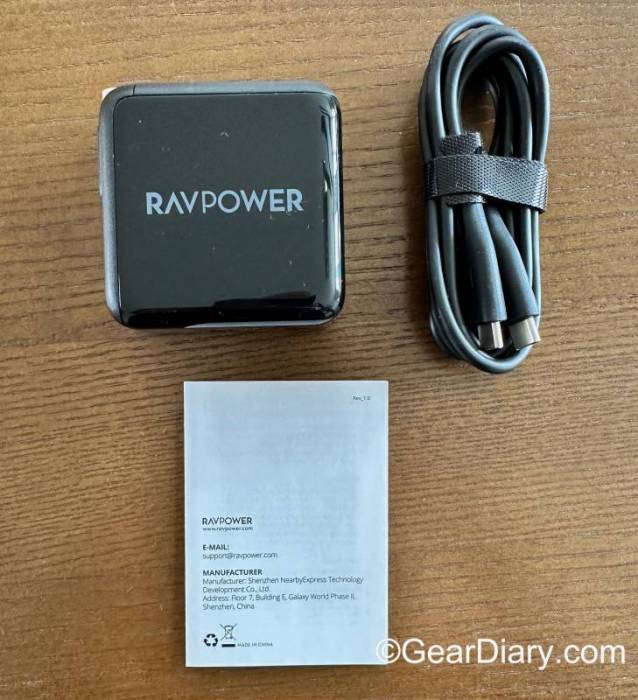 The RAVPower 100W 2 USB-C Ports PD Wall Charger, a charging cable, and the user manual