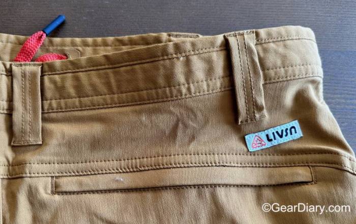 A closeup of the large zippered pocket on the rear right hip on a khaki pair of LIVSN Ecotrek Trail Shorts