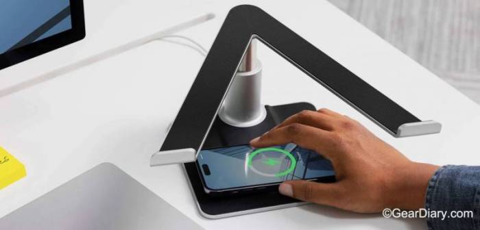 A man places his iPhone on the Twelve South HiRise Pro for MacBook's MagSafe charger