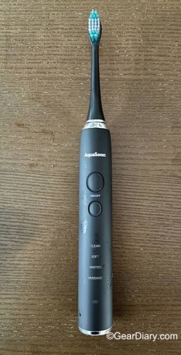 The AquaSonic Black Series Electric Toothbrush with a brush head attached