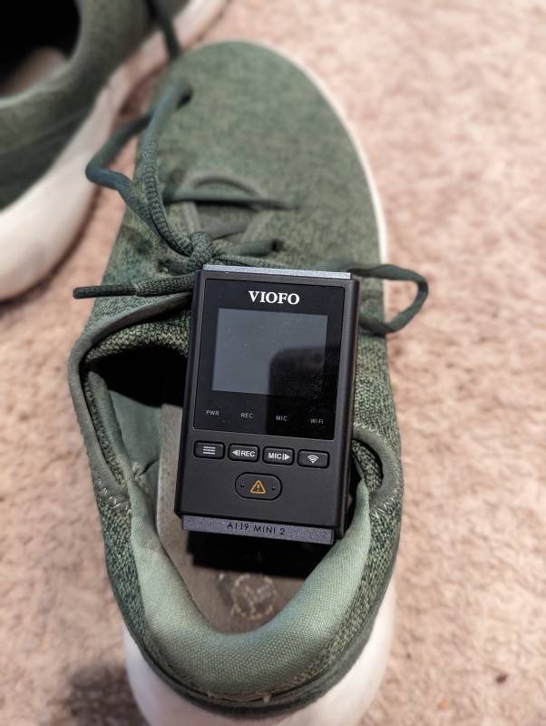 The Viofo A119 Mini 2 Dashcam shown in a comparison with the author's shoe