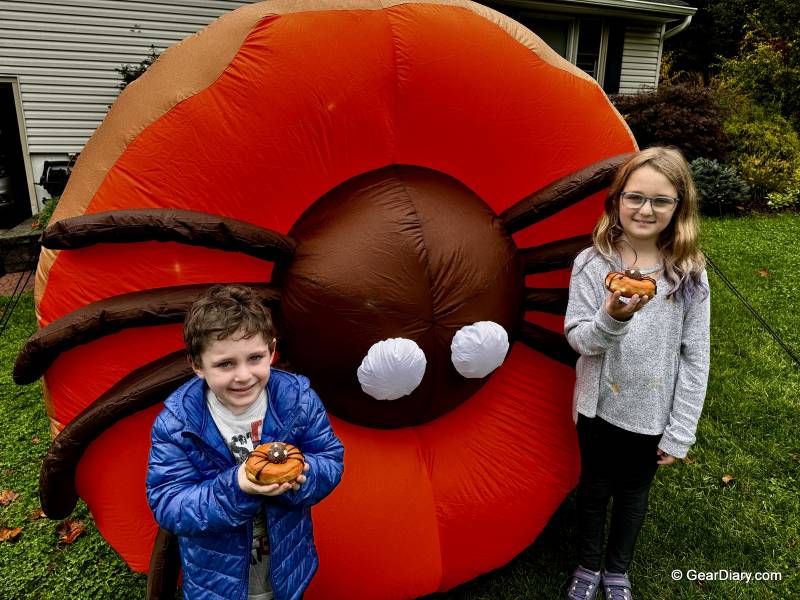 The author's children in front of the Dunkin' Inflatable Spider Donut holding Dunkin' Spider Donuts