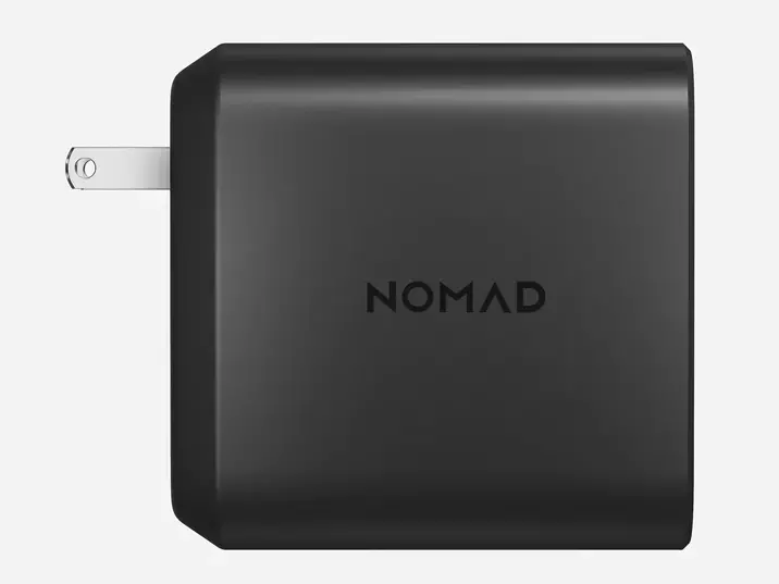 Side view of the Nomad 130W Power Adapter, showing the folding AC plug