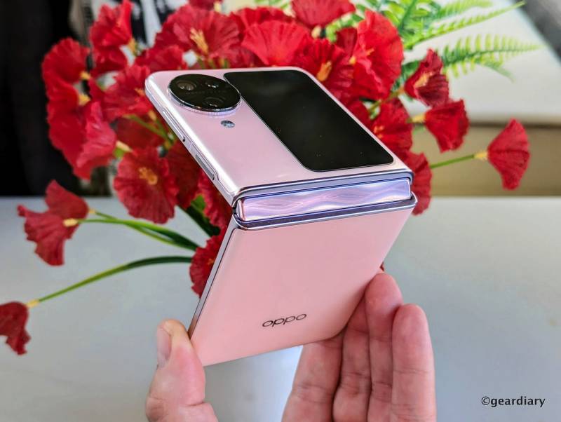 The author holds a pink Oppo Find N3 Flip in hand
