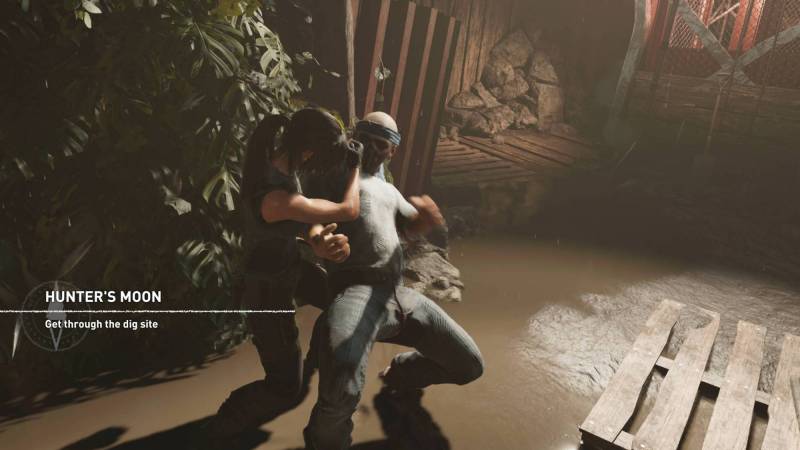 Lara Croft taking down a bad guy in Shadow of the Tomb Raider