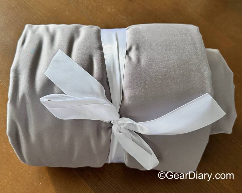 Light gray Honeydew Sheets wrapped with a white ribbon