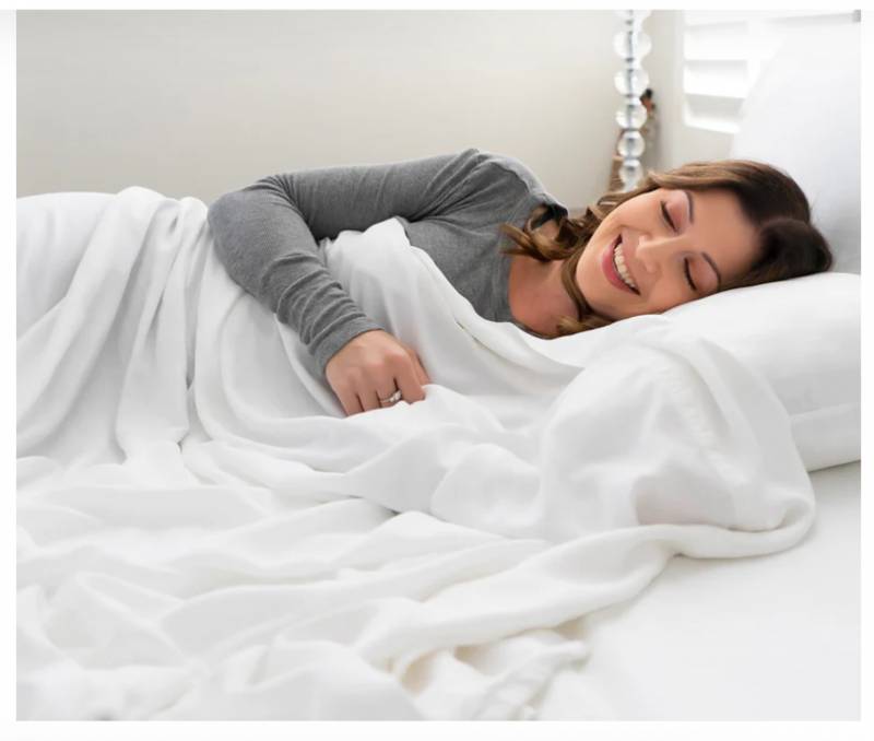 Woman sleeping on white Honeydew Sheets