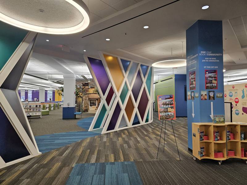 A colorful wall is located in a library.