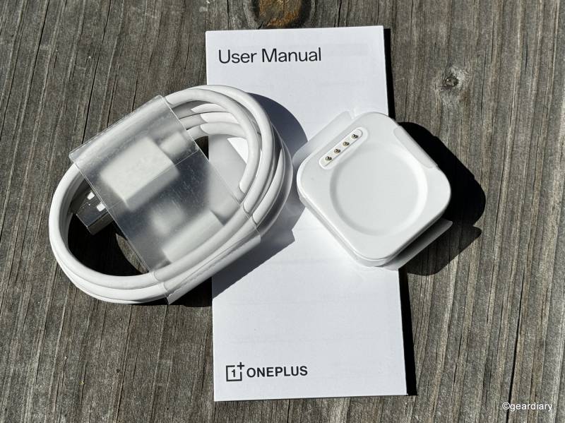 The OnePlus Watch 2's charger, cable, and paperwork