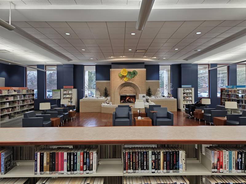 A fireplace is located in a library.