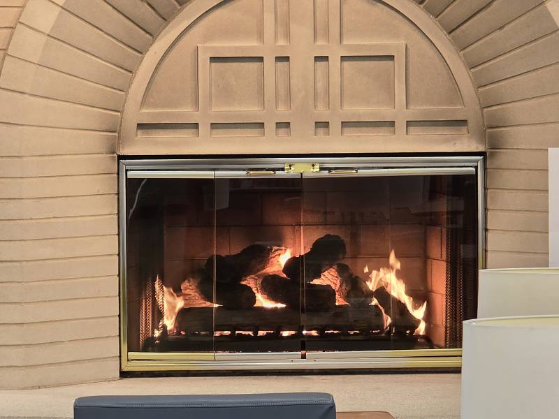 A fireplace is located in a library.