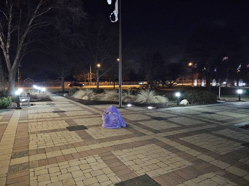 A woman sits on the ground.