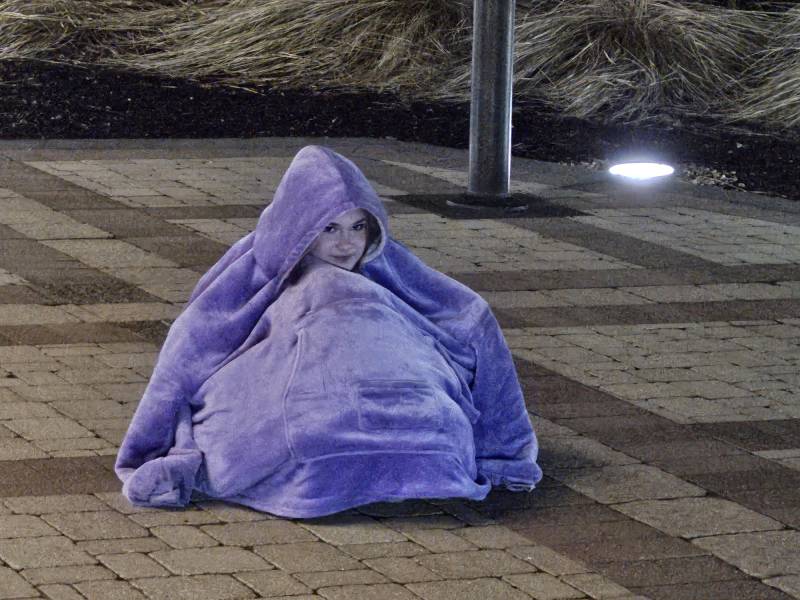 A woman sits on the ground.