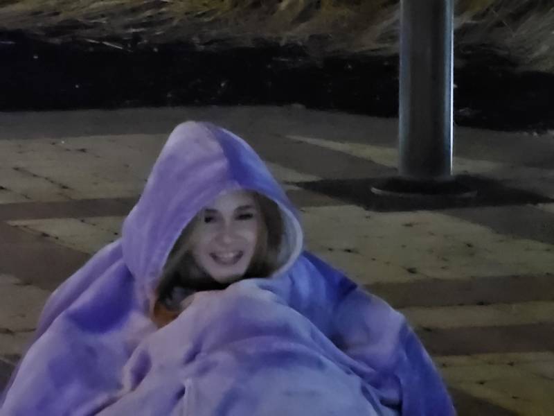 A woman sits on the ground.