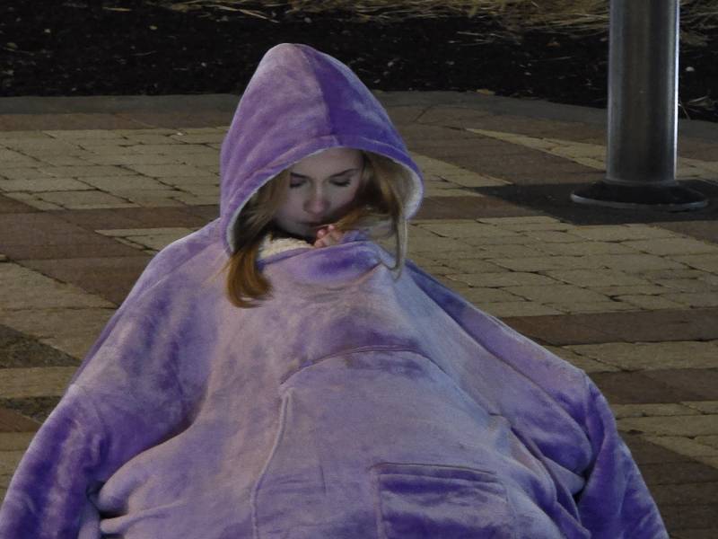 A woman sits on the ground.